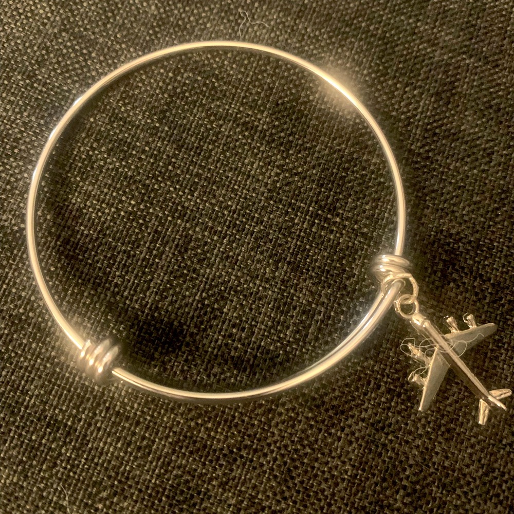 Jewelry on the Fly’s “Smooth Ride” Silver stainless steel bangle with jet charm